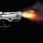 Pistol firing with bullet fire and smoke isolated on black side view