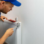 house heating system installation plumber installing radiator