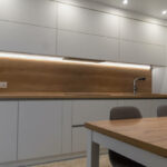 Beautiful modern minimalistic interior of a bright kitchen with lighting