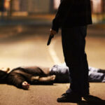 Man lying on the ground after being shot by a gun-wielding criminal